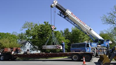 Crane loading a flat bed trailer