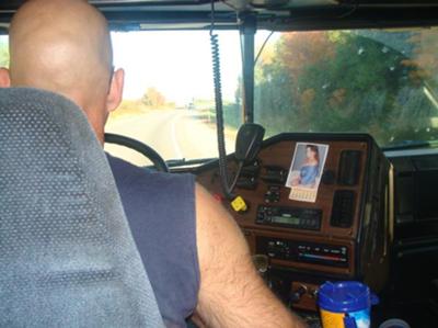 My Truck Driving Husband, doing what he does best! (yea that is me the pic on the dash board)