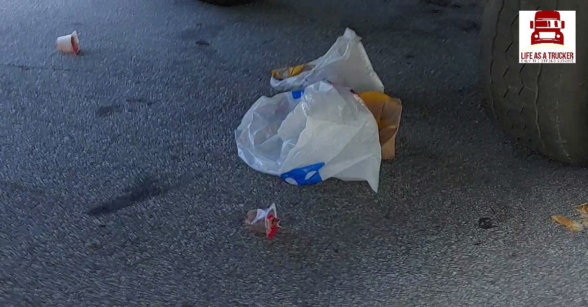 This person is an idiot.  Don't be like this trucker who throws trash on the ground where he/she parks.