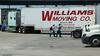 Trucker and rider walking across truck stop parking lot